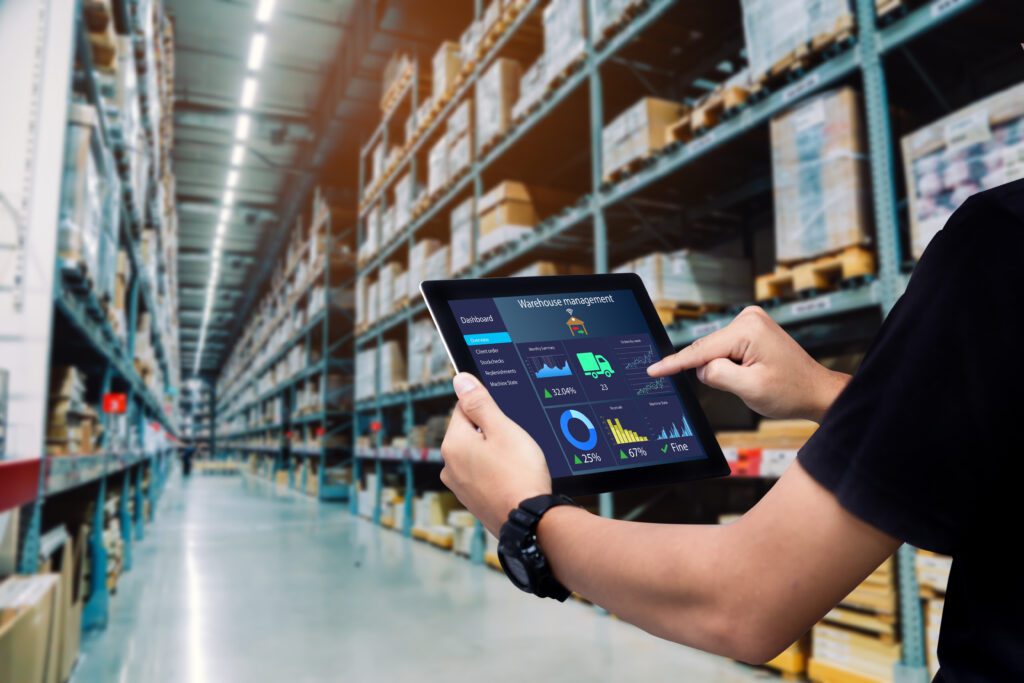 Persoon die in warehouse met Ipad loopt